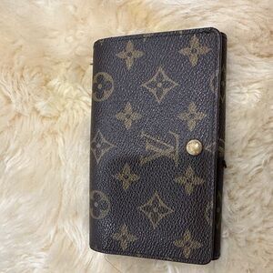 LV pre owned snap closure bifold , zip coin and slip pockets.